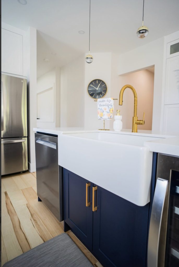 Farmhouse sink between the fridge and the dishwasher